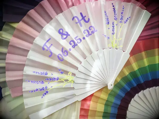 Personalized white fan with printed initials and wedding date