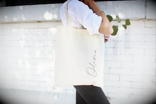 Woman using her beige personalized tote bag