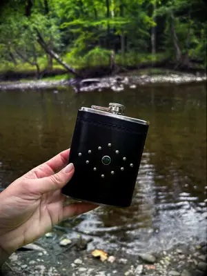 Leather covered flask with stud detailing