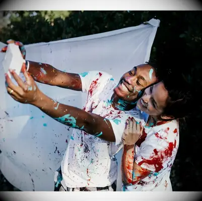 Couple taking a picture while having a paint fight