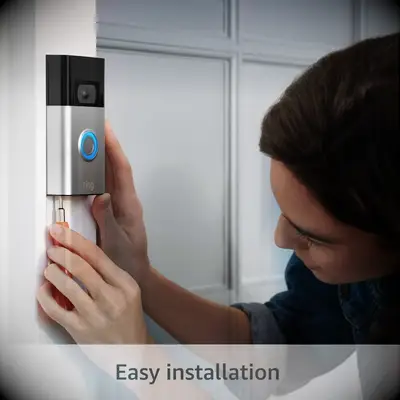 Woman installing a smart doorbell