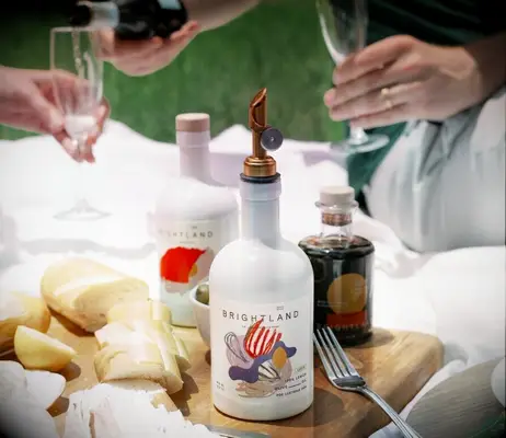 Various bottles of delicious infused olive oils displayed at an outdoor picnic. 