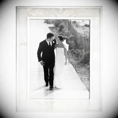 Elegant mother of pearl picture frame displaying a photograph of the newlyweds wedding gift for sister