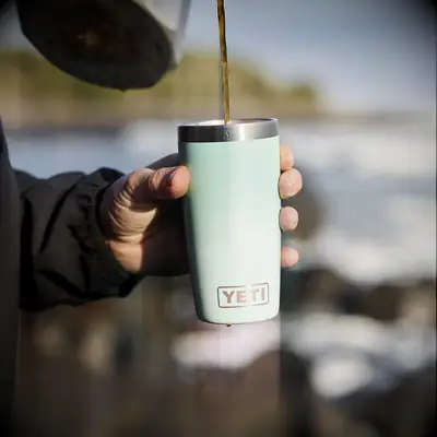 Man pouring a hot drink into a YETI flask