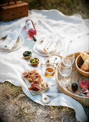 Picnic set up outside with wine and food for DIY anniversary gift