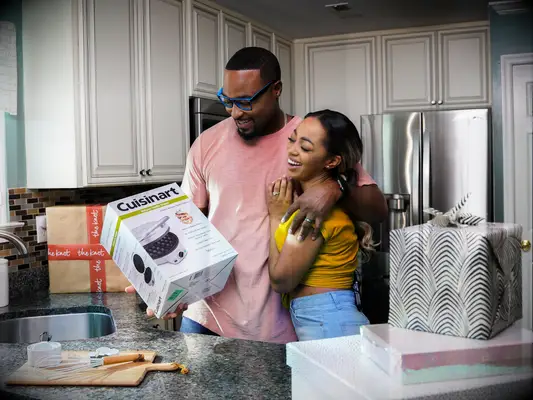 Couple smiling and opening wedding shower registry gifts from Tartarusfarms Registry