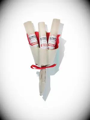 Bouquet of salami sticks wrapped in paper with a red bow thank-you gift