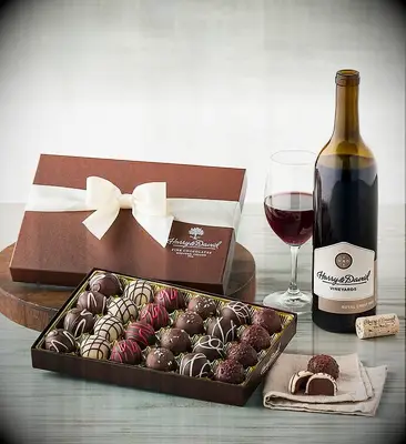Set of gourmet choclates and wine displayed on a dining table thank-you gift
