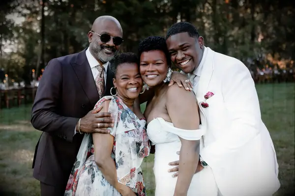 Bride and groom smiling with parents