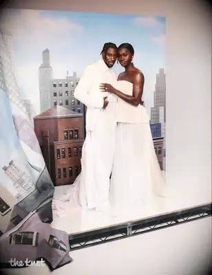 Noah Lyles and Junelle Bromfield the knot magazine cover summer 2025 issue, noah and junelle in front of cityscape