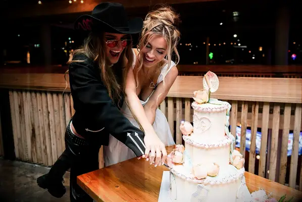 Chrishell and G Flip cutting the cake at their wedding
