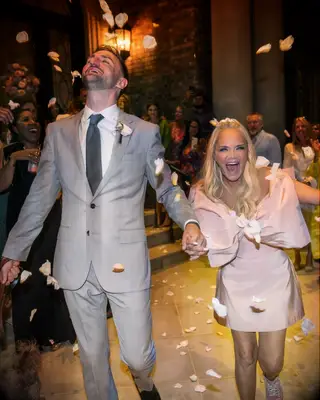 Kristin Chenoweth and Josh Bryant leaving their wedding reception