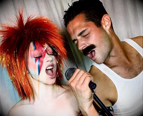 Sarah Hyland and Wells Adams as David Bowie and Freddie Mercury