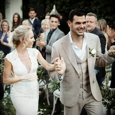 Romain and Mary Bonnet walking down aisle at wedding