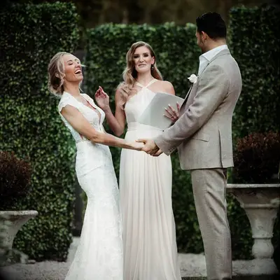 Mary Fitzgerald and Romain Bonnet laughing at altar on wedding day