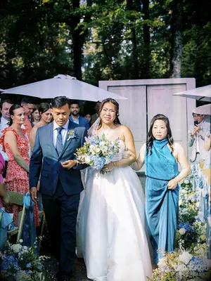 Mei Mei walking down the aisle with her parents