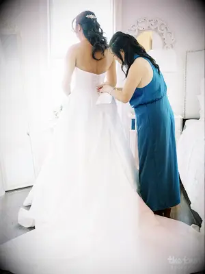 Mei Mei putting her wedding dress on