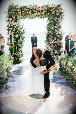 caila quinn wedding floral arch kiss