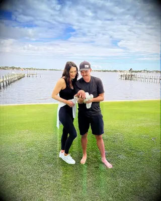 Rickie Fowler and wife Allison Stokke with their daughter Maya