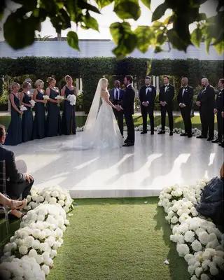 Kate and Tyler Seguin standing at the altar on their wedding day