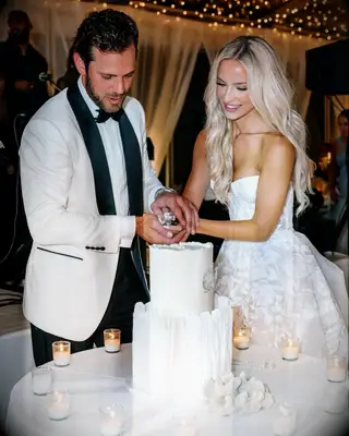 Kate and Tyler Seguin cutting cake on wedding day