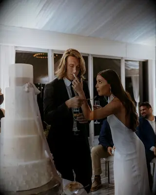 Trevor Lawrence and Marissa Lawrence sharing cake on wedding day