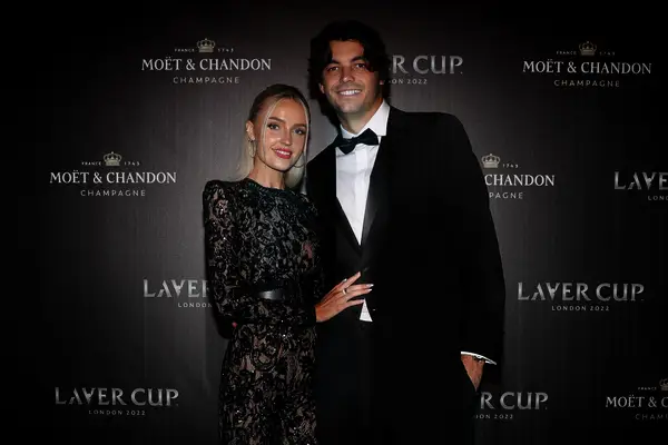 Taylor and Morgan pictured on a red carpet. 