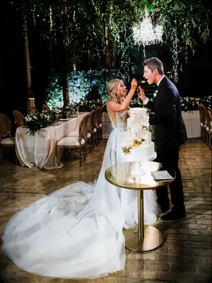 Lauren and Arie tasting their wedding cake