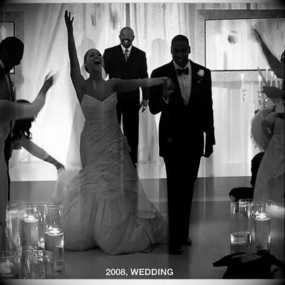 Beyonce and Jay-Z walk down the aisle at their wedding as newlyweds. 