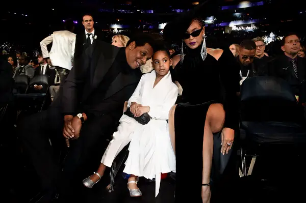 Beyonce, Jay-Z, and Blue Ivy pose for the camera at the Grammy Awards. 
