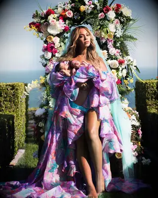Beyonce holds newborn twins Rumi and Sir in a whimsical photo shoot. 