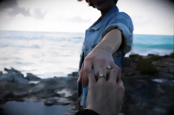 Chloë Grace Moretz and Kate Harrison holding hands with matching engagement rings