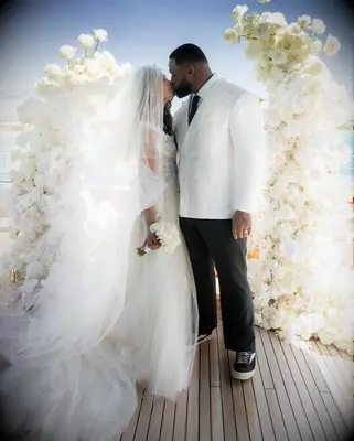 Chanel Iman and husband Davon Godchaux kissing on wedding day, 2025 celebrity wedding trends