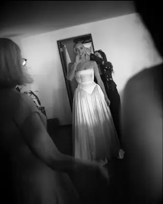 Black and white photo of Alex Cooper on wedding day in basque wedding dress, 2025 celebrity wedding trends