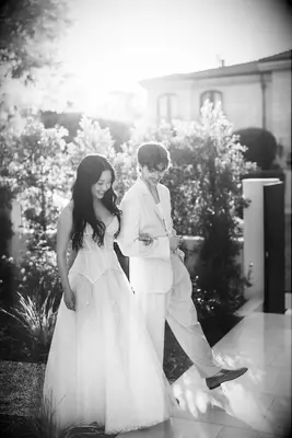 Black and white photo of Lana Condo and husband Anthony De La Torre at backyard rehearsal dinner, 2025 celebrity wedding trends