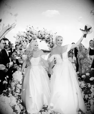 Rebel Wilson and wife Ramona Agruma wearing duet attire on wedding day, 2025 celebrity wedding trends