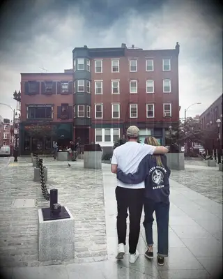 Meghann Fahy and Leo Woodall walking together