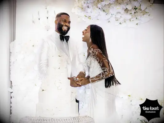 Chiney and husband Raphael cutting their wedding cake
