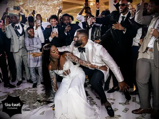Chiney and husband Raphael doing the money dance at their wedding reception