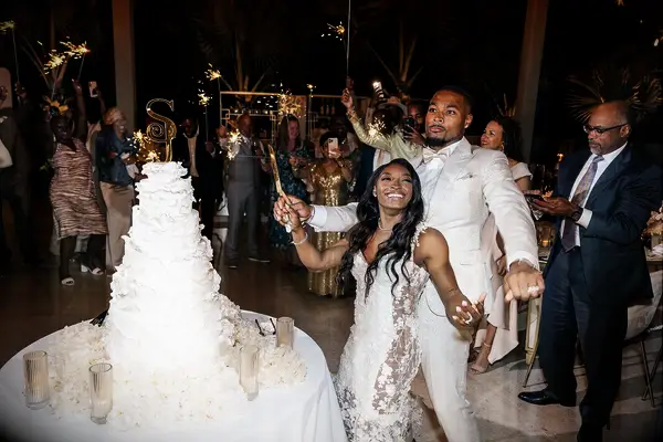 Simone Biles and Jonathan Owens cutting wedding cake