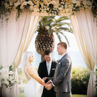 Zach and Julie Ertz holding hands at their wedding ceremony