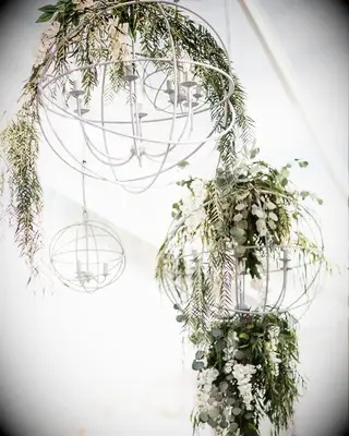 Hanging lights decorated with greenery at Zach and Julie Ertz