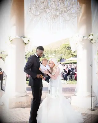 Julius and Kendra Randle with their son at their wedding