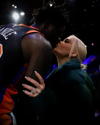 Julius and Kendra Randle kissing at a Knicks game