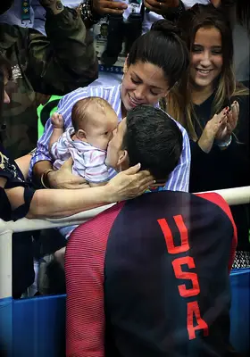 Michael Phelps with Nicole Johnson and their baby son Boomer at the Olympics in 2016