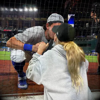 Cody Bellinger and Chase Carter kissing at a game