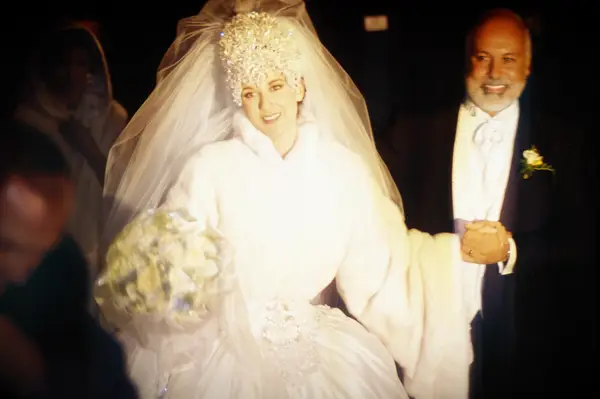 Celine Dion wearing white fur coat on wedding day