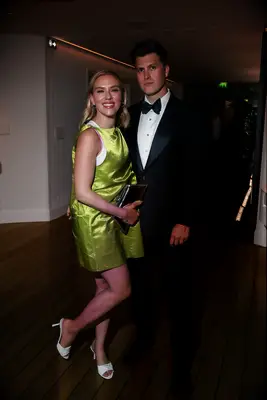 Scarlett Johansson and Colin Jost smiling together at event