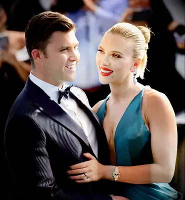 Scarlett Johansson and Colin Jost smiling on red carpet