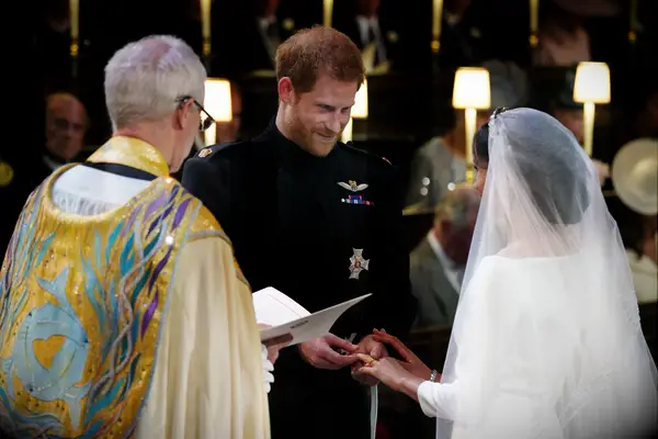 Harry and Meghan putting on rings during wedding ceremony